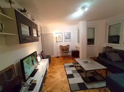 a living room with a couch and a tv at ParkWest Arena Belgrade Lux Apartment in Belgrade