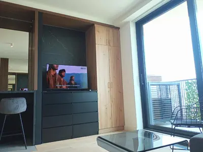 a living room with a flat screen tv on a wall at Beograd na vodi - BW City View in Sajmište