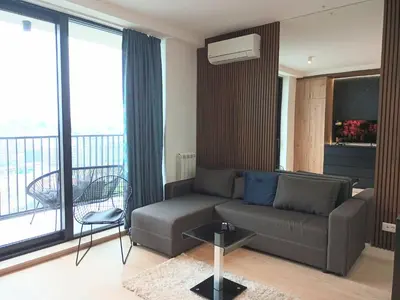 a living room with a couch and a balcony at Beograd na vodi - BW City View in Sajmište