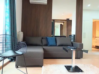 a living room with a couch and a table at Beograd na vodi - BW City View in Sajmište