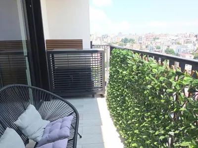 a balcony with two chairs and a view of a city at Beograd na vodi - BW City View in Sajmište