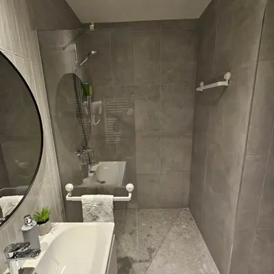 a bathroom with a sink and a mirror at Belgrade Waterfront Galerija Apartment in Sajmište