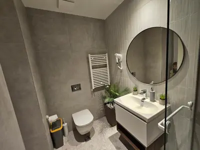a bathroom with a white sink and a mirror at Belgrade Waterfront Galerija Apartment in Sajmište