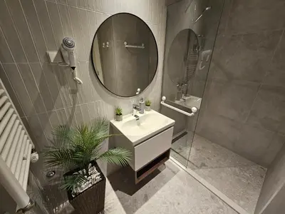 a bathroom with a sink and a mirror at Belgrade Waterfront Galerija Apartment in Sajmište