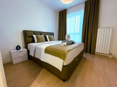 a bedroom with a large bed and a large window at Exceptional Belgrade Waterfront Apartment - Beograd na Vodi in Belgrade