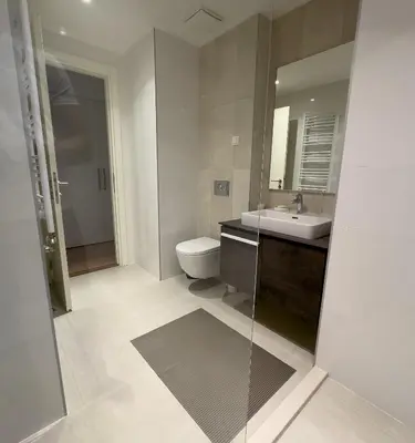a bathroom with a toilet and a sink and a mirror at Exceptional Belgrade Waterfront Apartment - Beograd na Vodi in Belgrade
