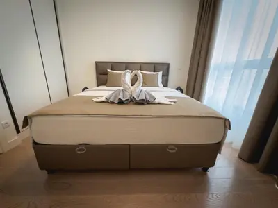 a bed with two swans sitting on top of it at Exceptional Belgrade Waterfront Apartment - Beograd na Vodi in Belgrade