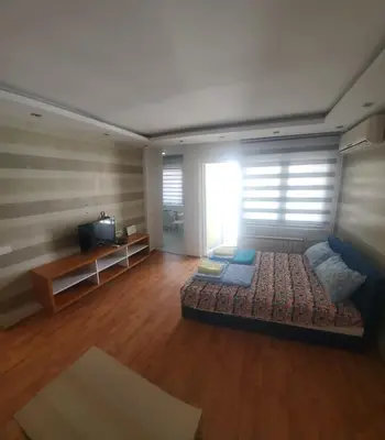 a large living room with a couch and a television at Blok 2 in Belgrade