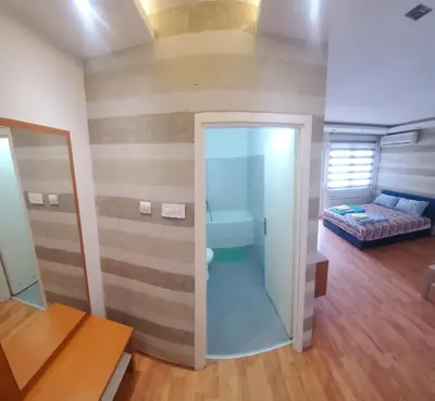 a bathroom with a toilet and a bed in a room at Blok 2 in Belgrade