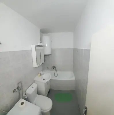 a white bathroom with a toilet and a bath tub at Blok 2 in Belgrade