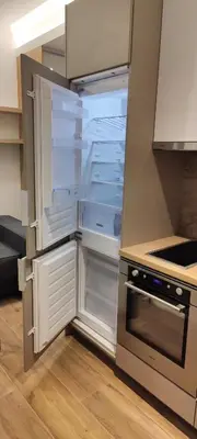 an empty refrigerator with its door open in a kitchen at Apartman Oki in Belgrade