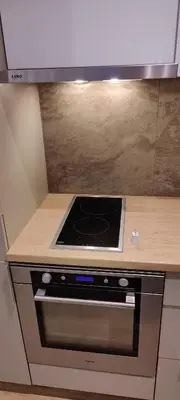 a stove top oven in a kitchen with a counter at Apartman Oki in Belgrade