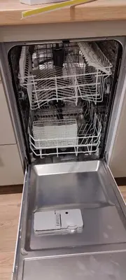 an empty dishwasher with a cell phone inside of it at Apartman Oki in Belgrade