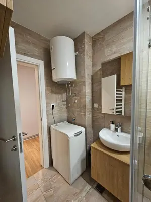 a bathroom with a white sink and a mirror at Apartman Oki in Belgrade