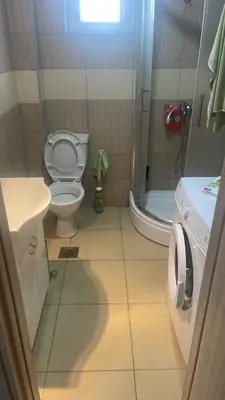 a small bathroom with a toilet and a shower at Stan 3 UB in Ub
