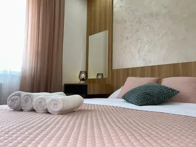 a hotel room with a bed with towels on it at Perla Lux 2 Apartments in Arandjelovac