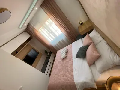 an overhead view of a bed in a small room at Perla Lux 2 Apartments in Arandjelovac