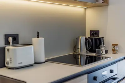 a kitchen with a sink and a coffee maker at Chic Studio on the Belgrade's Waterfront in Belgrade