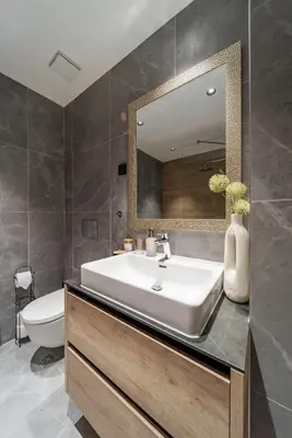 a bathroom with a white sink and a mirror at Chic Studio on the Belgrade's Waterfront in Belgrade