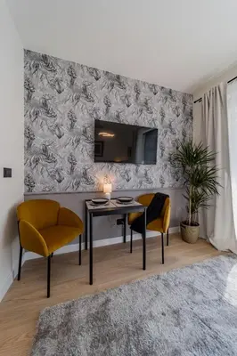 a living room with a table and two chairs and a tv at Chic Studio on the Belgrade's Waterfront in Belgrade
