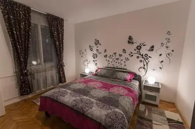 a bedroom with a bed and a window at Top of Pop in Belgrade