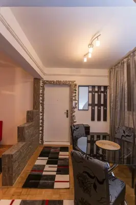 a room with a door and a table and chairs at Top of Pop in Belgrade