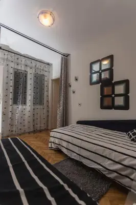 a bedroom with a bed and a large mirror at Top of Pop in Belgrade