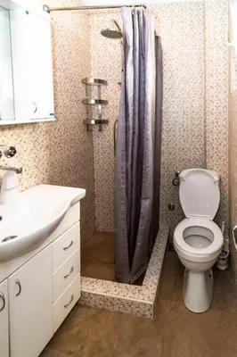a bathroom with a toilet and a sink and a shower at Top of Pop in Belgrade