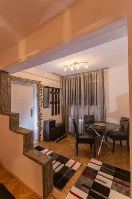 a living room with a table and a dining room at Top of Pop in Belgrade