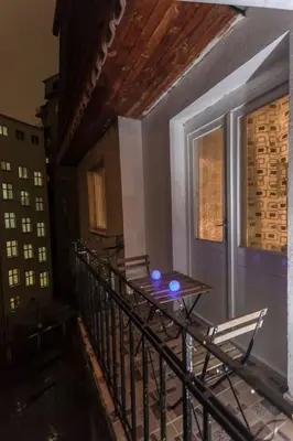 a balcony with a table and chairs and a window at Top of Pop in Belgrade
