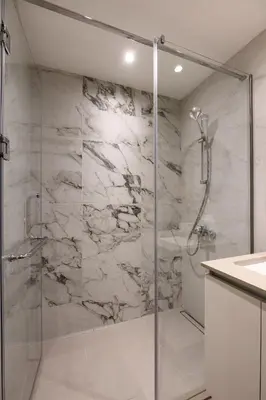 a bathroom with a shower with a glass door at inJoy in Sajmište