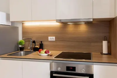 a kitchen with a sink and a bowl of fruit at inJoy in Sajmište