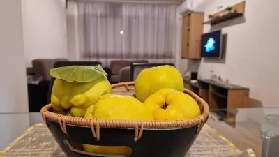 a basket of yellow fruit on a table at Apartman Dunja in Ruma