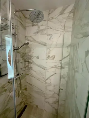 a shower with a glass door in a bathroom at Garden Oasis in Belgrade