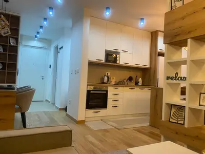 a kitchen with white cabinets and a stove at Garden Oasis in Belgrade
