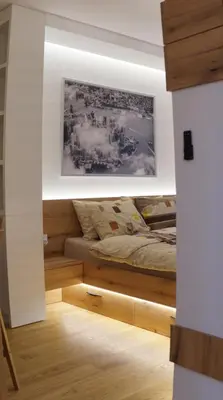 a bedroom with a bed with a picture on the wall at Garden Oasis in Belgrade