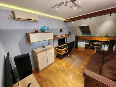 a living room with a couch and a desk at Earth & Sky apartment in Sajmište