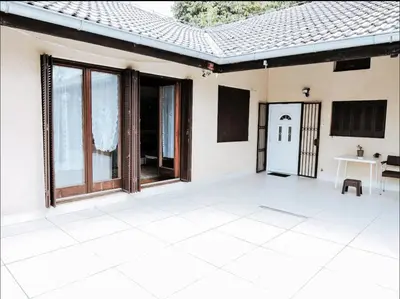 a white house with a table and a window at Vila Avala in Belgrade