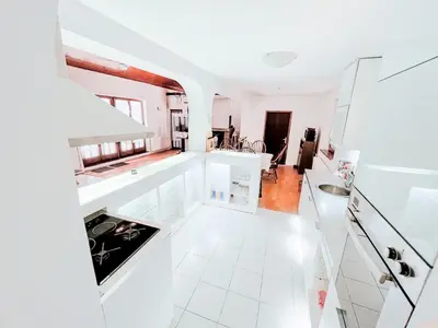 a kitchen with white tile flooring and white counters at Vila Avala in Belgrade
