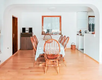 a dining room with a table and chairs and a kitchen at Vila Avala in Belgrade