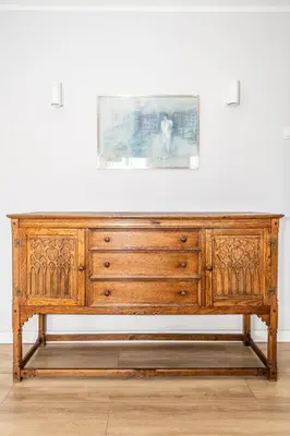 a wooden dresser against a white wall with a picture at 7 Heaven in Belgrade
