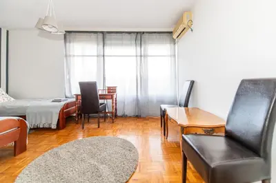 a living room with a couch a chair and a table at 7 Heaven in Belgrade