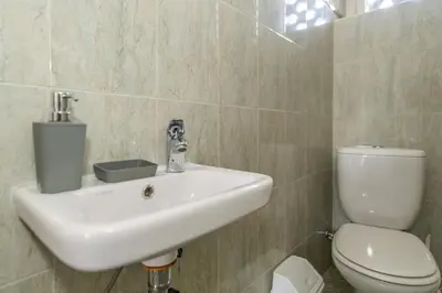 a bathroom with a white sink and a toilet at 7 Heaven in Belgrade