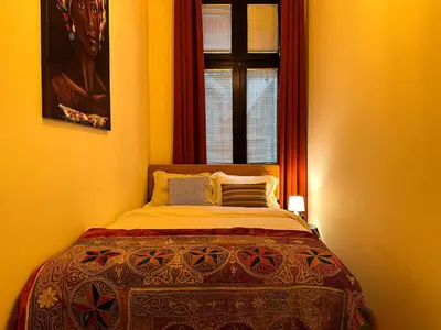 a bed in a room with a window and a bedspread at Friends Loft with Terrace & River View Old Town in Belgrade