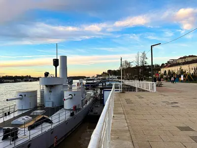 a boat docked at a dock in the water at Friends Loft with Terrace & River View Old Town in Belgrade