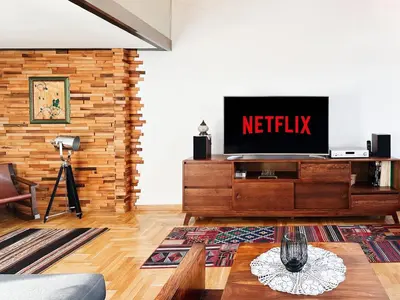 a living room with a television on a wooden dresser at Friends Loft with Terrace & River View Old Town in Belgrade