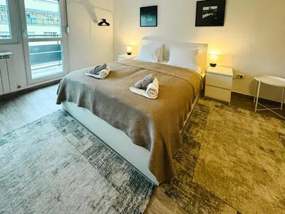 a bedroom with a large bed with towels on it at Terrace Charm 25 in Belgrade