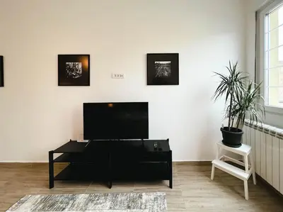 a living room with a flat screen tv on a white wall at Terrace Charm 25 in Belgrade