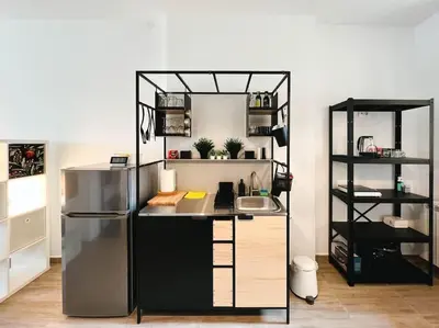 a kitchen with a desk and a refrigerator at Terrace Charm 25 in Belgrade