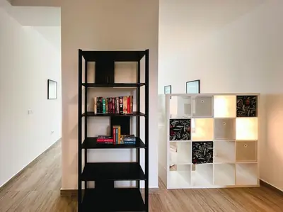 a black book shelf in a room with books at Terrace Charm 25 in Belgrade